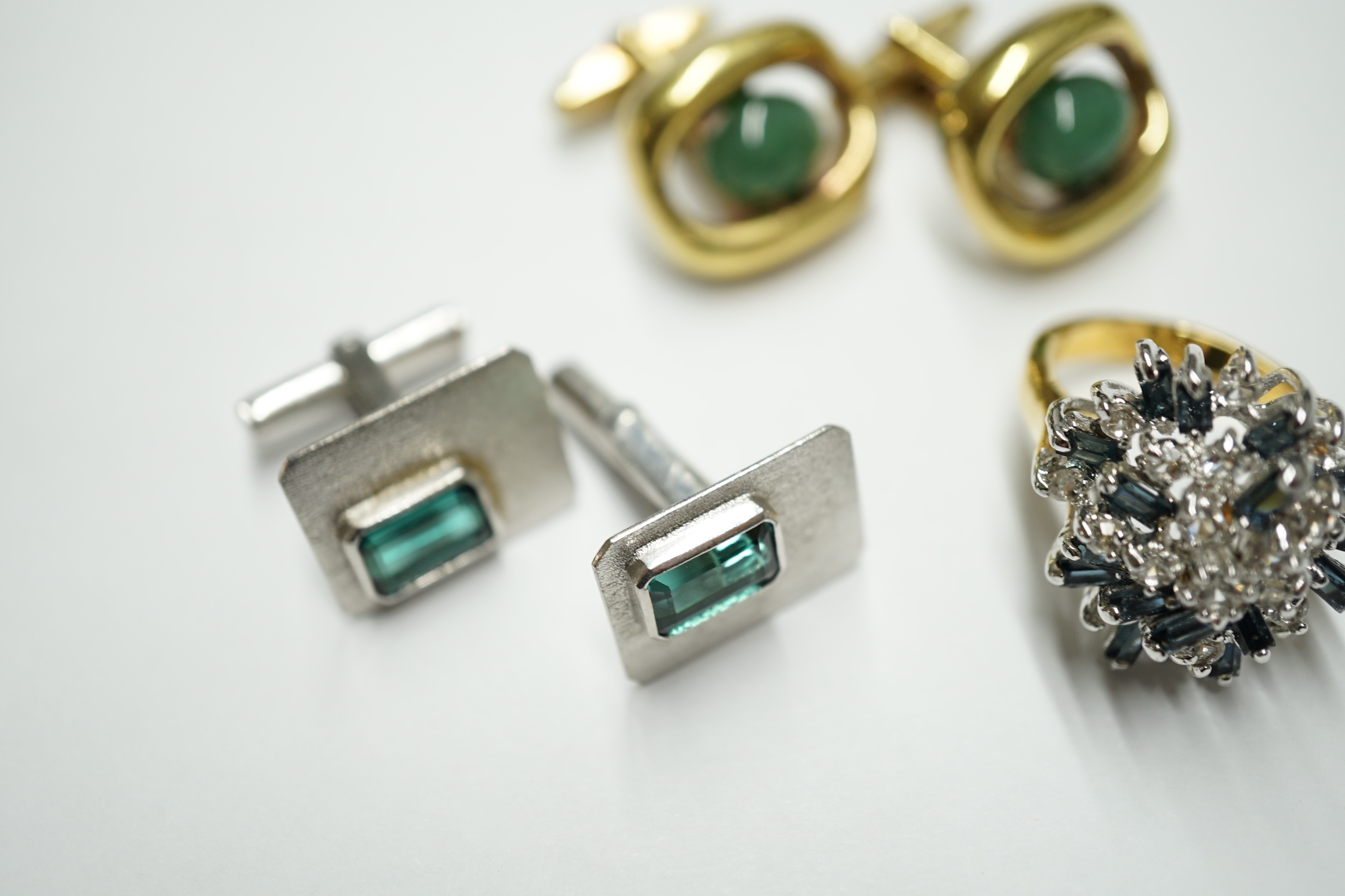 A pair of Lanvin gold plated cufflinks, each set with an oval green cabochon, a pair of silvered metal cufflinks set green stones and a costume ring. Condition - fair